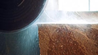 Makine mermer bloğu kesiyor. Taş ocağındaki bir fabrikada mermer testeresi.