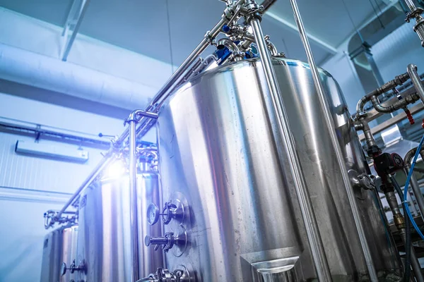 Dairy production. Apparatus for bottling milk products. Steel tanks at milk factory.