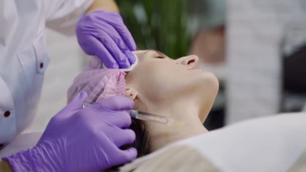 美容院美容师手戴手套 面对女性颈部注射抗衰老药物 女人做美容面部美容术 肉毒杆菌 — 图库视频影像
