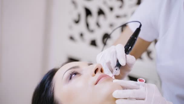 一位专业纹身艺术家在美容院为客户做唇彩化妆品 模糊的背景 — 图库视频影像
