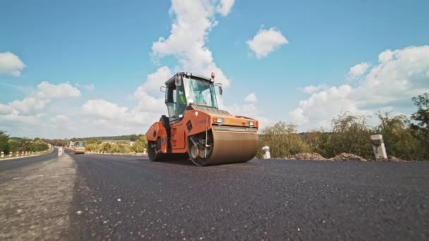 道路に新しいアスファルトを敷設 ヘビーバイブレーションローラーコンパクタ付き道路補修機 — ストック動画