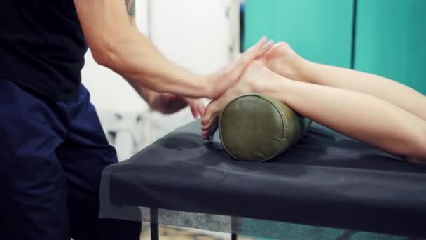 Woman Legs Lying Roller Black Table Massagist Doing Massage Barefoot — Stock Video