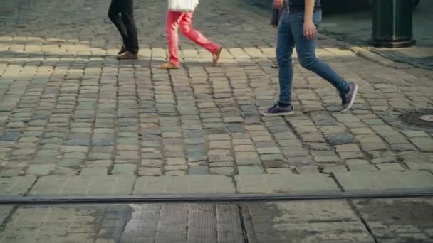 リヴィウの古い舗装路のメインストリートを横断する歩行者 雨の後 古代都市の道路上の人々の足の動き — ストック動画