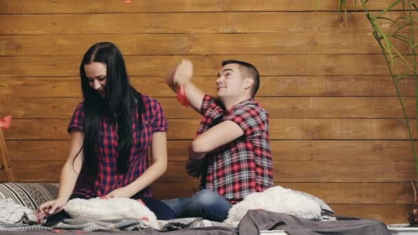 Yatakta Tahta Duvarda Kırmızı Kağıt Kalplerle Oynayan Romantik Bir Çift — Stok video