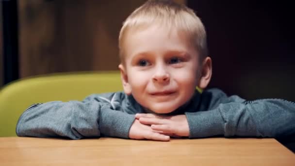 Happy Young Boy Sitting Wooden Table Room Little Blond Kid — Stock Video