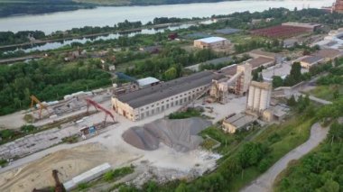 Nehrin kenarındaki kuş bakışı inşaat alanında. Nehrin kıyısındaki endüstriyel fabrika binaları. Hava görünümü.