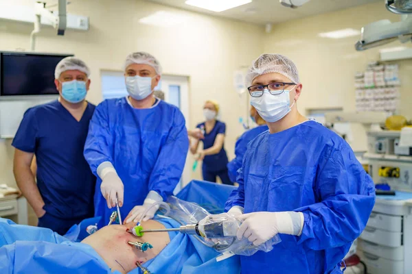 Surgeon operating with medical robotic surgery machine. Manual control by Minimally Invasive Surgical System. Modern automated medical device. Surgical room in hospital with robotic technology equipment, machine arm neurosurgeon. Closeup of neurosurg