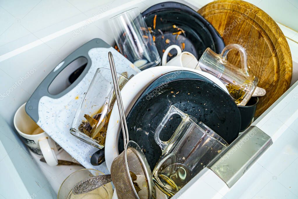 Kitchen sink with dirty dishes and utensils. Mess and sink. Dirty kitchen utensils