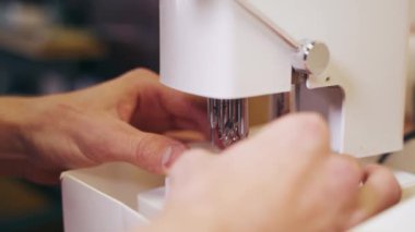 Optik makinede gözlük merceğiyle çalışan bir uzman. Gözlük üretimi. Lens yapmak için modern ekipman.