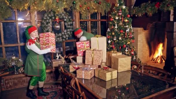 Two Elves Standing Specially Decorated Room Table Holding Presents Hands — Stock Video