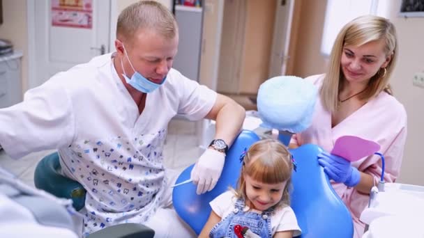 치과에 귀여운 조수와 종양학자가 소녀의 이빨을 치료하기 했습니다 — 비디오