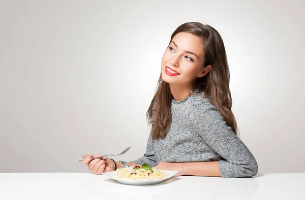 Young brunette having Italian food. — Stock Photo, Image