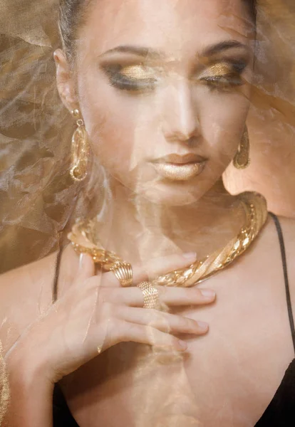 Woman wearing gold jewelry. — Stock Photo, Image