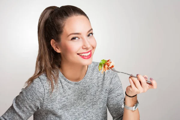 Young brunette having Italian food. — Stock Photo, Image