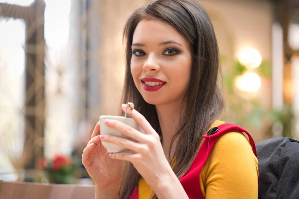 Brünette trinkt Cappuccino. — Stockfoto