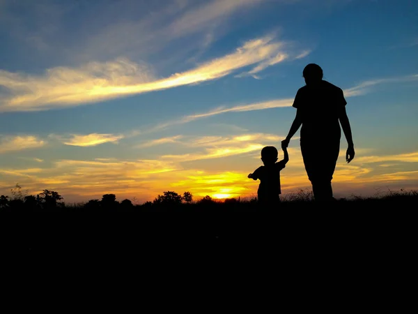 剪影母亲和孩子与暮光之天空 — 图库照片
