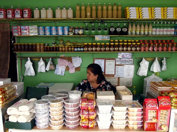 A lady sits in her sweet snacks and delicacy store in a tourist spot in Tagaytay City, Philippines. — Stock Photo, Image