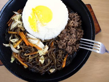 Cızırtılı bir tabak içinde Kore yemeği