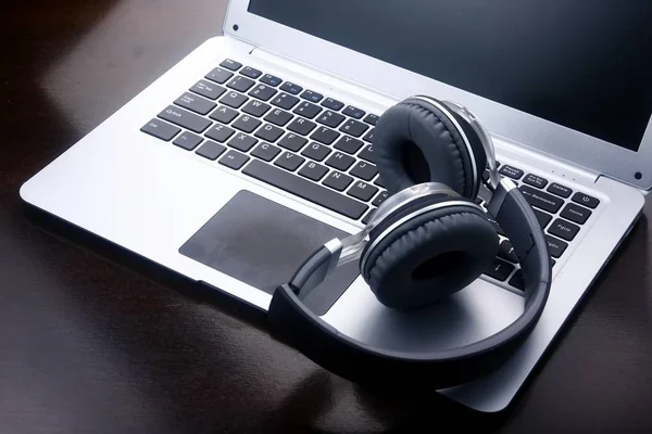 Headphones on a laptop computer.