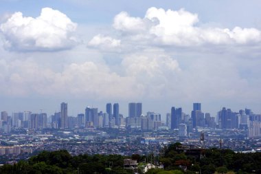 An aerial view of commercial and residential buildings and establishments in the towns of Cainta, Taytay, Pasig, Makati and Taguig as seen from the mountainous city of Antipolo. clipart