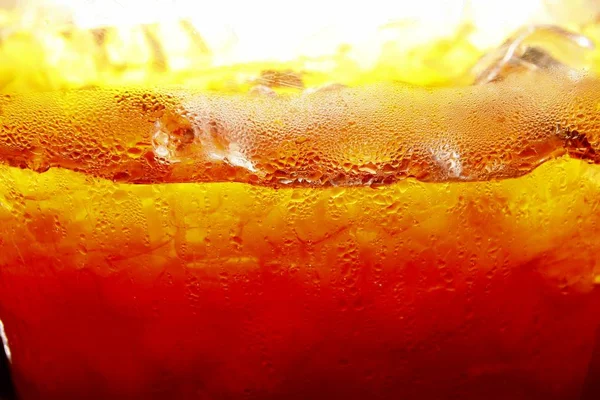 Mixed cold iced tea in a glass container — Stock Photo, Image