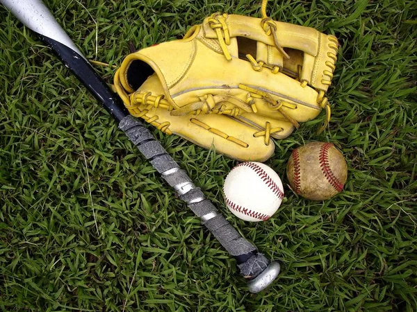 Baseball gloves, baseball and a baseball bat
