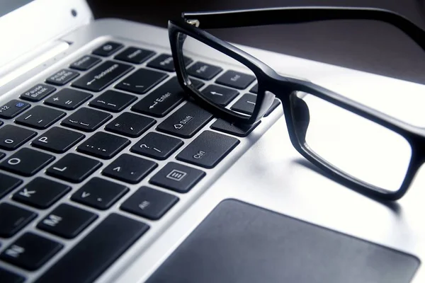 Eyeglasses on a laptop computer keyboard