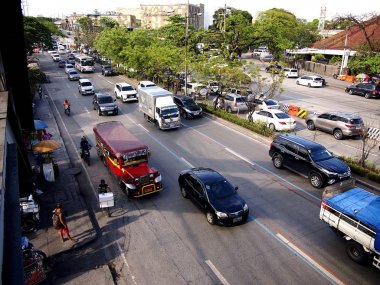 Araç geçmek boyunca bir genellikle sıkışık trafik Katipunan Avenue Quezon City, Filipinler.