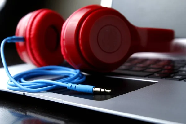 Stereo headphones and a laptop computer — Stock Photo, Image