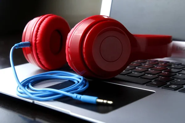 Stereo headphones and a laptop computer — Stock Photo, Image