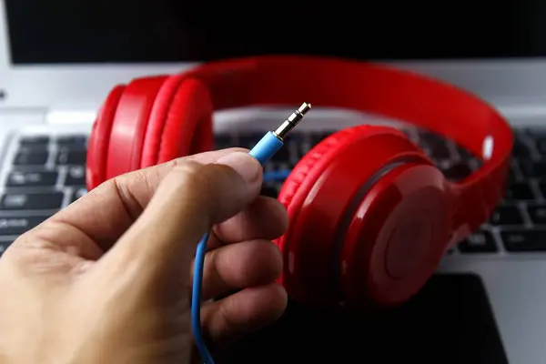 Cable of stereo headphones and a laptop computer — Stock Photo, Image