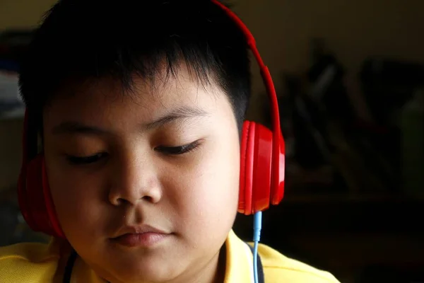 Jovem menino asiático com fones de ouvido — Fotografia de Stock