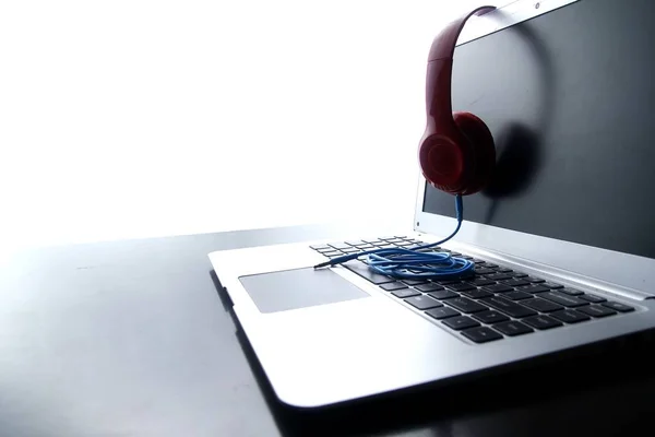 Stereo headphones and a laptop computer — Stock Photo, Image