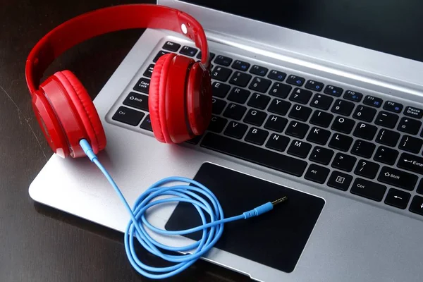 Stereo headphones and a laptop computer — Stock Photo, Image