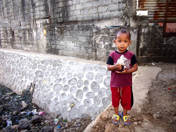 Young Filipino boy stops playing to pose for the camera. — Stock Photo, Image