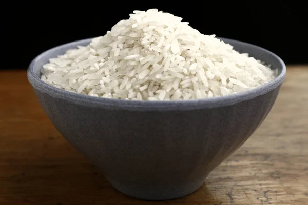 Bowl of raw rice on a table