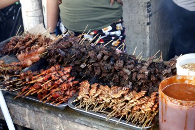 Assorted grilled pork innards such as intestine, liver, gizzard and blood in barbecue sticks