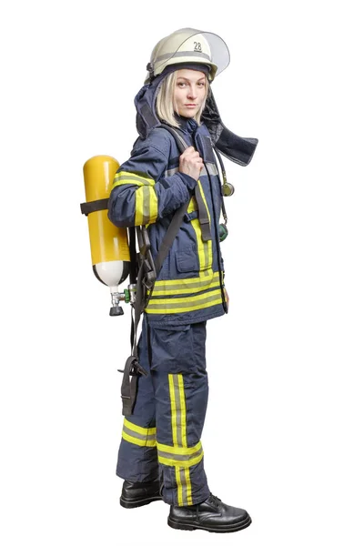 Young woman firefighter wearing uniform and helmet with air pack on her back isolated — Stock Photo, Image