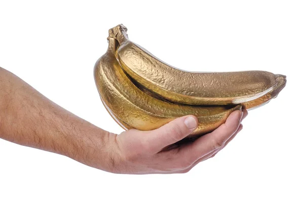 Рука людини тримає купу золотих бананів ізольовані на білому тлі . — стокове фото