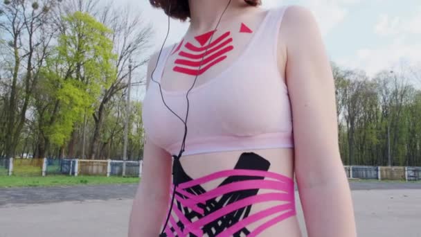 Young Caucasian Girl Kinesiology Tape Her Belly Chest Posing Park — Stock Video