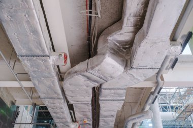 Air conditioning under a bare ceiling. ventilation pipe system