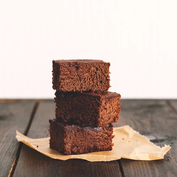 Brownie, chocolate cake on a dark rustic wooden table. tinted beige Stock Picture