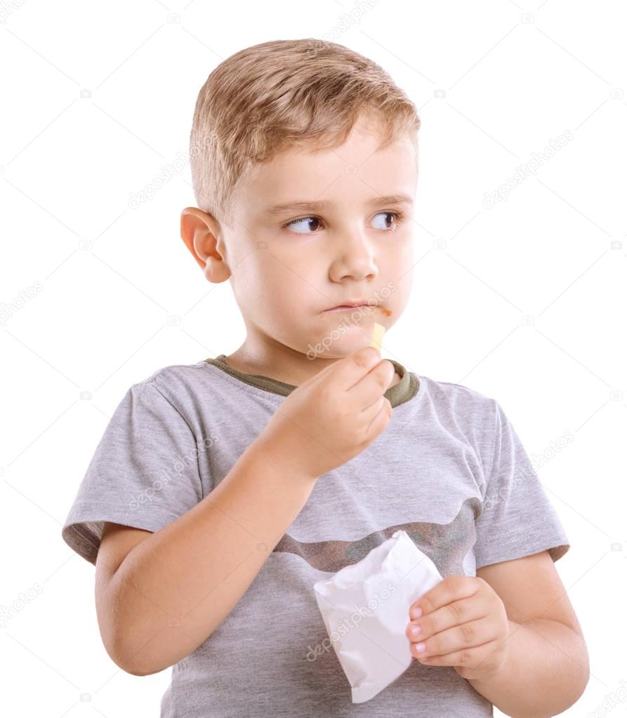 A dreamy boy with likable blond hair  which eats a fragnant meal isolated on a white  background. The unbelievable boy dressed in a gray T-shirt is holding a box of food in his left hand.