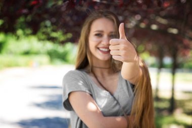 Güneşli bir arka plan üzerinde poz neşeli bir bayan. Sağlıklı bir kız veren bir 