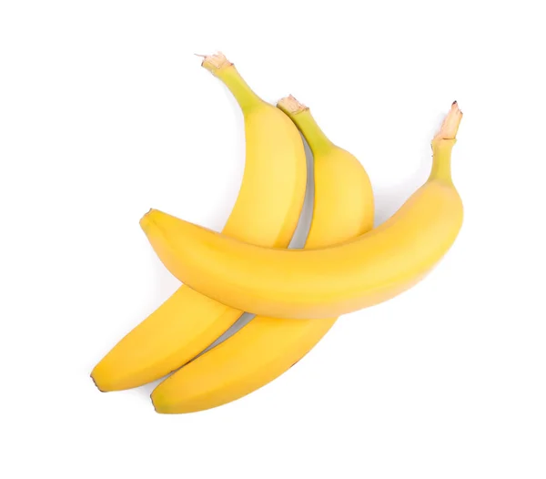 Banane intere, biologiche, fresche e giallo brillante, isolate su fondo bianco. Tre dolci frutti di banane . — Foto Stock