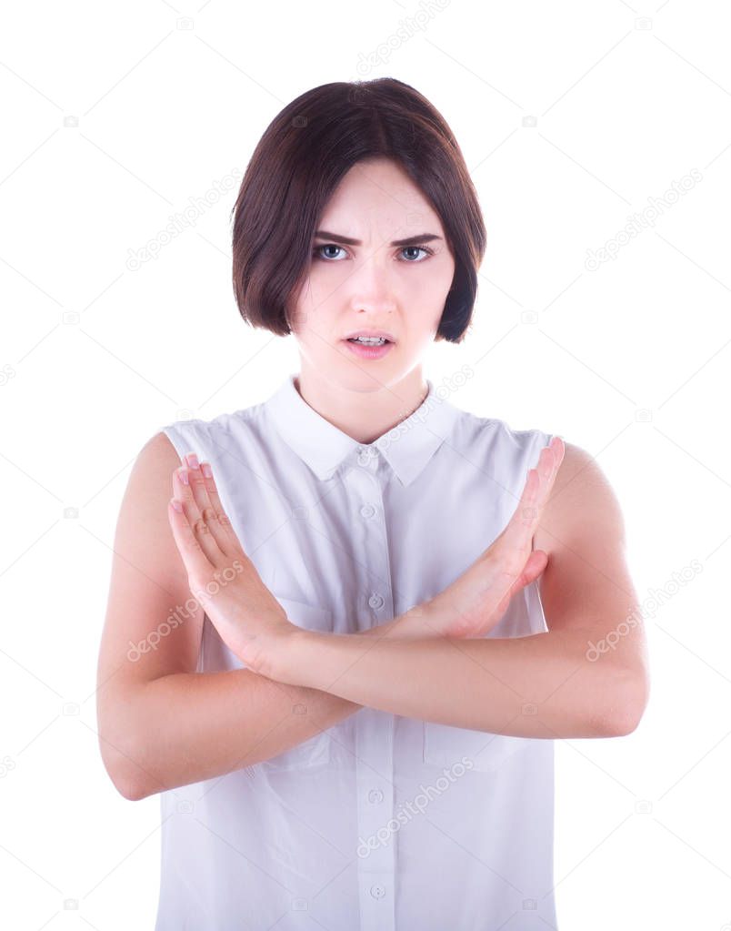 Stop gesture with indignation shown by a young woman in elegant clothes, isolated on a white background. A beautiful girl says no.