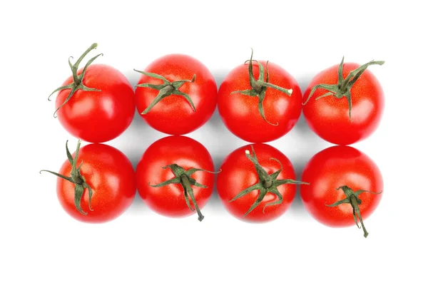 Lato żniwa jasne czerwone pomidory z zielonych liści na białym tle na białym tle. Pełne witamin warzywa. Soczyste, dojrzałe i świeże pomidory. — Zdjęcie stockowe
