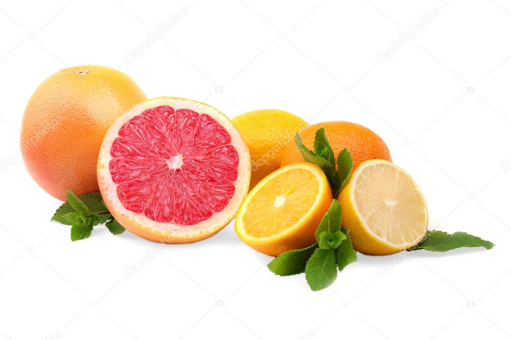 Several kinds of multi-colorful, whole and cut citrus fruits, isolated on a white background. Exotic and tropical grapefruits, oranges and lemon with leaves.