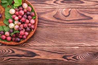 Çok renkli bektaşi ve taze kahverengi ahşap sepet bir masada bırakır. Renkli meyveler besleyici vitamin dolu. Yakın çekim sağlıklı ve taze bektaşi. 