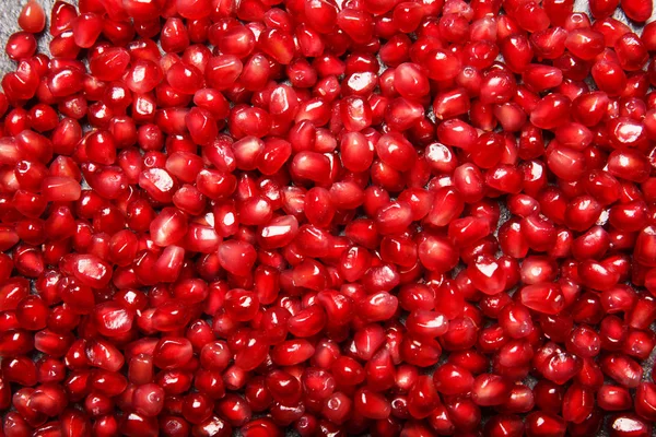 Granathintergrund. Granatapfel-Hintergrund. saftige rote Granatapfelkerne. natürliche fruchtige Zutaten für gesunde Säfte. — Stockfoto